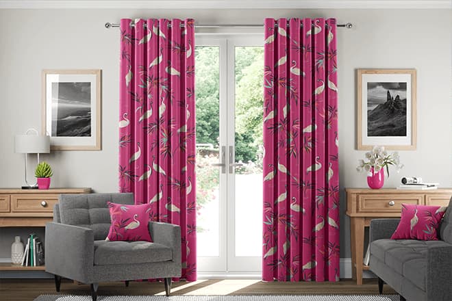 Stylist draping curtain fabric samples in a client's living room